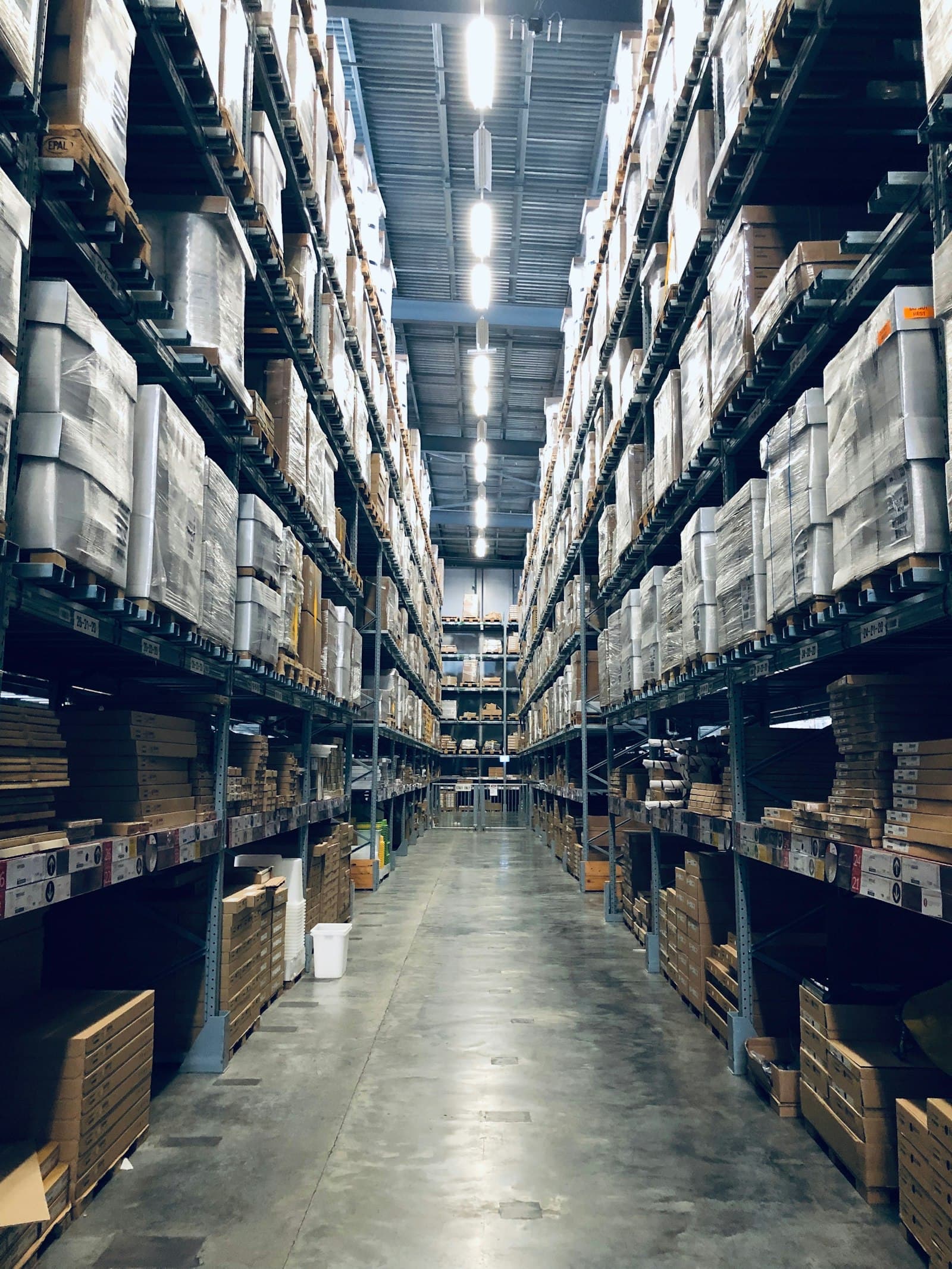 Warehouse aisle with shelves of boxed stock